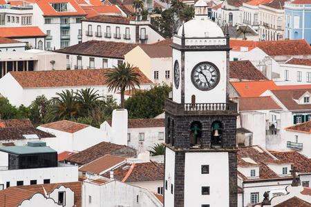 Saint Sabastian church with clock tower in Ponta Delgada on Sao Miguel Island in Azores, Portugal. Beautiful church in early morning under white clouds.の写真素材