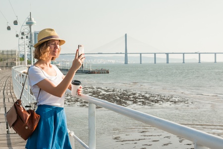Attractive young woman walking in Lisbon near Tajus river at Park of the Nationsの写真素材