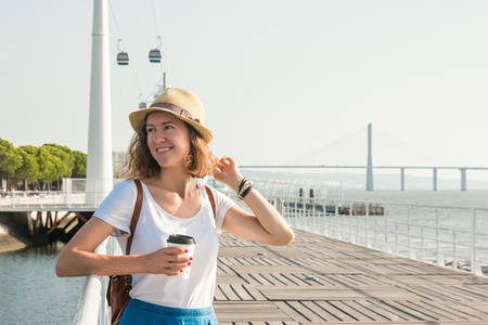 Attractive young woman walking in Lisbon near Tajus river at Park of the Nationsの写真素材