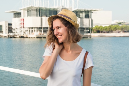 Attractive young woman make photo near Lisbon Oceanarium near river Tagusの写真素材