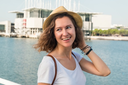 Attractive young woman make photo near Lisbon Oceanarium near river Tagusの写真素材