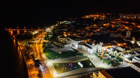 Aerial view of harbor, central square, fort and old city walls of Lagos, Algarve, Portugal at nightの写真素材