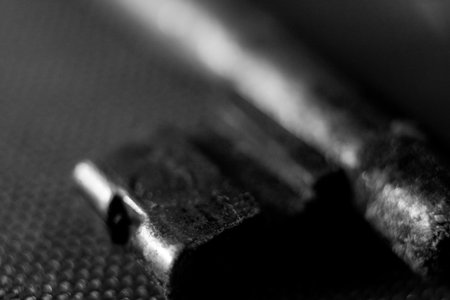 Close up of a metal key on a black background. Macro.の写真素材
