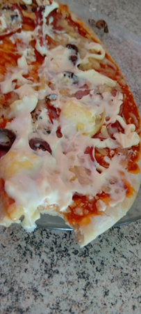 Pizza with ham and mozzarella cheese. Italian cuisine.の写真素材