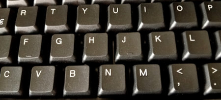 Keyboard with black letters close-up. Conceptual photo of computer technology.の写真素材