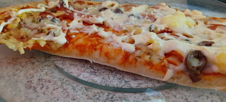 Pizza with ham, cheese, mushrooms and mozzarella.の写真素材