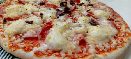 Pizza with mozzarella cheese, tomatoes and olives. Italian cuisineの写真素材
