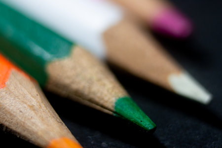 Colored pencils on a black background close-up macro photographyの写真素材