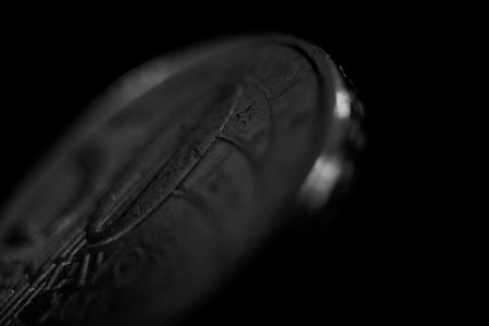 Close up of a coin on a black background. Monochrome.の写真素材