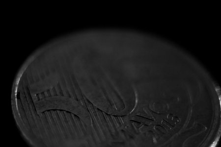 Close up of real coin on black background. Monochrome.の写真素材