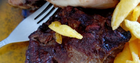 steak with french fries on a plate, close-up.の写真素材