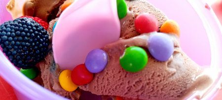 Close up of ice cream in a bowl with colorful candies.の写真素材