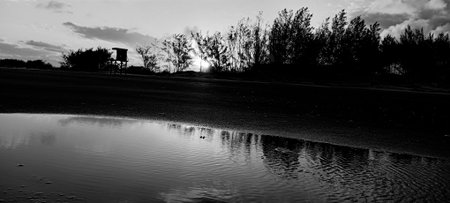 Black and white landscape image with reflection on waterの写真素材