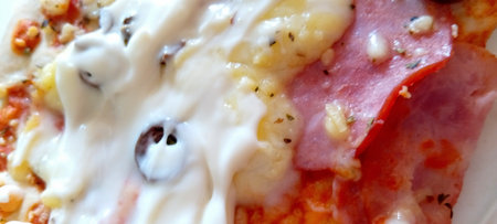 Pizza with ham and mozzarella cheese. Close-up.の写真素材