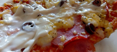 Pizza with mozzarella cheese, tomatoes and olives.の写真素材