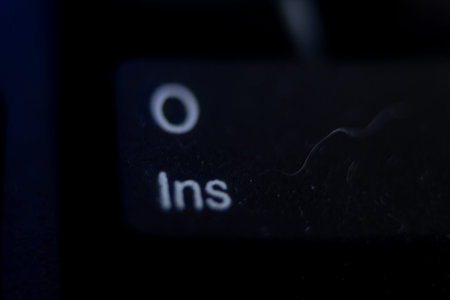 Close up shot of a black button on a computer keyboard