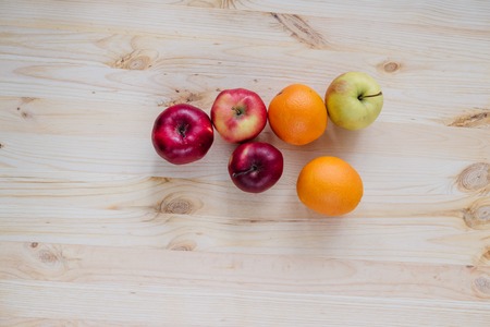 Fresh red and green apple, orange on wooden decks. Fruit, citrus table. Colorの写真素材