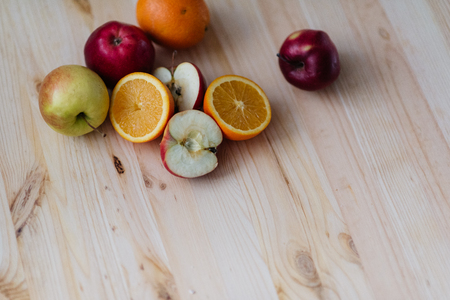 Fresh red and green apple, orange on wooden decks. Fruit, citrus table. Colorの写真素材
