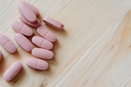 Close up several pills on the desk. Concept of pharmacology and medical supplies.の写真素材