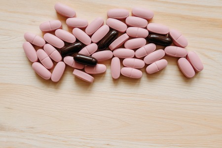 Close up several pills on the desk. Concept of pharmacology and medical supplies.の写真素材