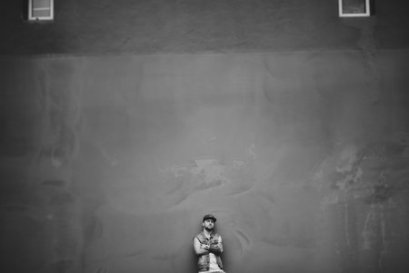 Street dancing man urban fashion with beard. Wearing black cap. Concrete environment.の写真素材