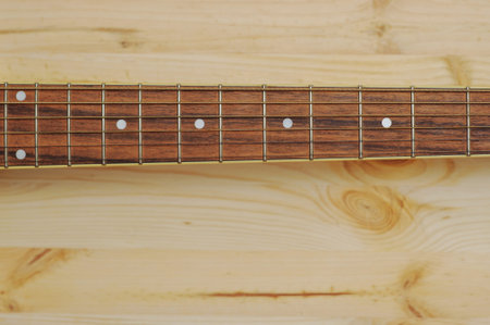 Acoustic guitar on wood desk background. Color