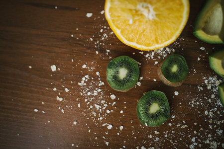 Fresh kiwi, avocado, orange on the desk. Healthy eating Color