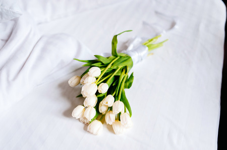 White beautiful wedding tulips on fresh towels in hotel, close upの写真素材