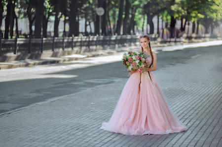 Wedding flowers bride ,Woman holding colorful bouquet with her hands on wedding dayの写真素材