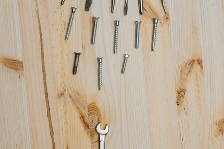 Collection of screwdriver, wrench, bolts and screws on the desk. Color.の写真素材