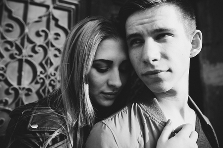 Couple has fun and laughs. kiss. Young hipster couple hugging each other in city. Spring love story, a beautiful stylish young couple. Fashion concept with boyfriend and girlfriend.の写真素材