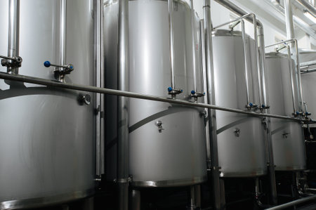 Modern brewery and equipment machinery tools for alcohol production. Steel vats or tanks and stainless pipes.のeditorial素材