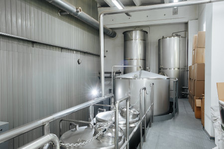 Modern brewery and equipment machinery tools for alcohol production. Steel vats or tanks and stainless pipes.のeditorial素材