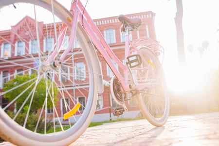 Close up pink bicycle at sunset time. Cycle, pedal. Selective focus.の写真素材