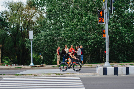KHARKIV, UKRAINE - August 2, 2020: Triathon biking cyclist triathlete riding racing bike during ironman competition. Road cycling athlete in tri suit and helmet. Public events are allowed. Europe sport during CV pandemic.のeditorial素材