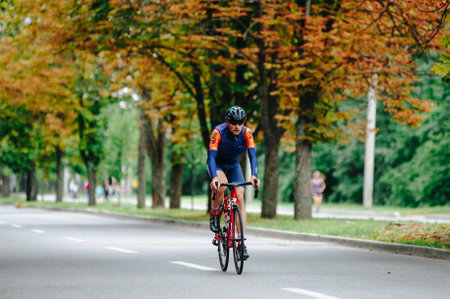 KHARKIV, UKRAINE - August 2, 2020: Triathon biking cyclist triathlete riding racing bike during ironman competition. Road cycling athlete in tri suit and helmet. Public events are allowed. Europe sport during CV pandemic.のeditorial素材