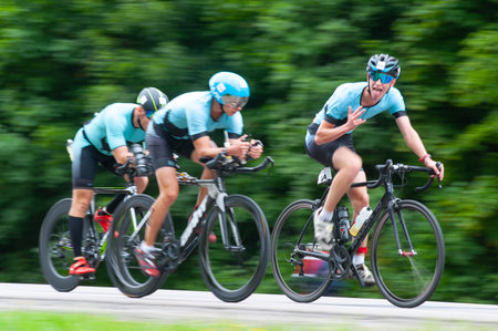 KHARKIV, UKRAINE - August 2, 2020: Triathon biking cyclist triathlete riding racing bike during...