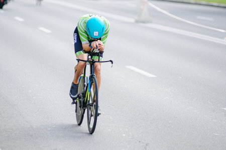 KHARKIV, UKRAINE - August 2, 2020: Triathon biking cyclist triathlete riding racing bike during ironman competition. Road cycling athlete in tri suit and helmet. Public events are allowed. Europe sport during CV pandemic.のeditorial素材