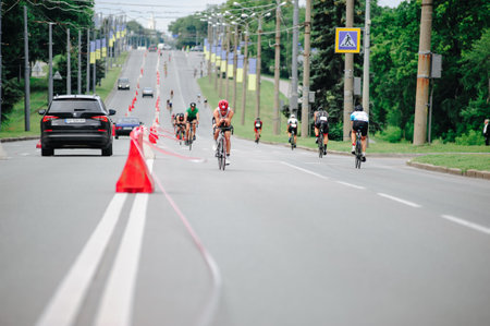 KHARKIV, UKRAINE - August 2, 2020: Triathon biking cyclist triathlete riding racing bike during ironman competition. Road cycling athlete in tri suit and helmet. Public events are allowed. Europe sport during CV pandemic.のeditorial素材