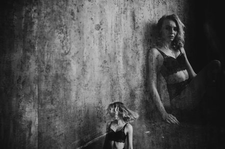 Blond woman in black lingerie. Double exposure photo. Art of photography