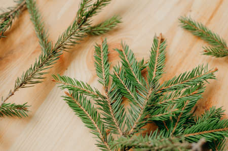Christmas fir branches on a wooden table.の写真素材