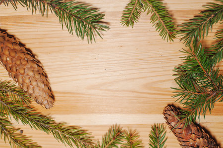 Christmas fir branches on a wooden table.