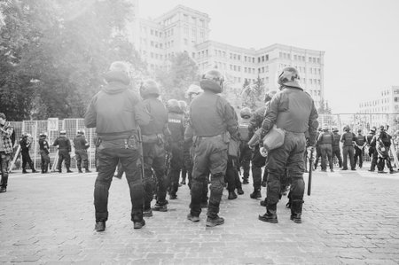 Kharkiv, Ukraine - September 15, 2019: Kharkiv Pride. Group of police officers security guarding peaceful protest. Ukraine Police watch for rights people.のeditorial素材