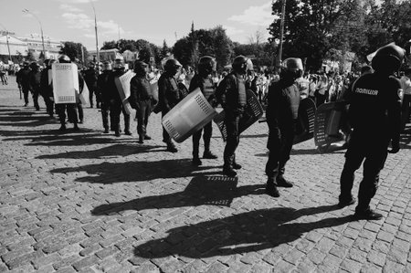 Kharkiv, Ukraine - September 15, 2019: Kharkiv Pride. Group of police officers security guarding peaceful protest. Ukraine Police watch for rights people.のeditorial素材