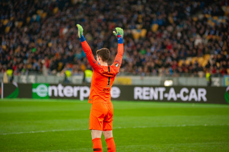 KYIV, UKRAINE - MARCH 14, 2019: Goalkeeper of Chelsea Kepa Arrizabalaga hands up in action during the match of UEFA Europa League at NSC Olimpiyskyi stadium in Kyiv. Rear view.のeditorial素材