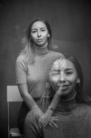 Close up emotional portrait of happy blonde woman. Monochrome, black and white. Motion blur and double exposureの写真素材