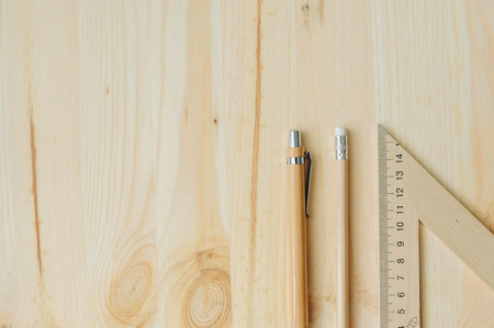 Wood pencil, pen, triangle on the desk in daylight Office table in daylight