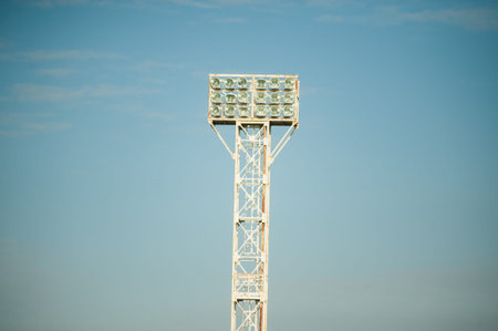 Floodlights over the field with clouds in the background.