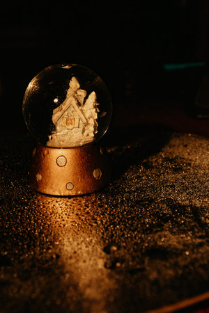 Snow Globe with drops. Table view and gold christmas items.