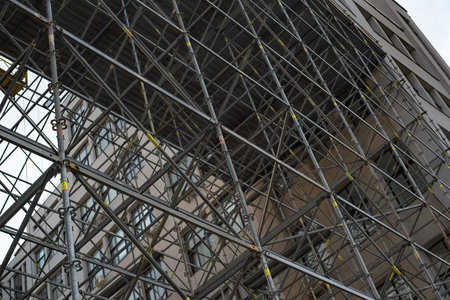 Construction site of building. Extensive scaffolding providing platforms for work in progress on a...